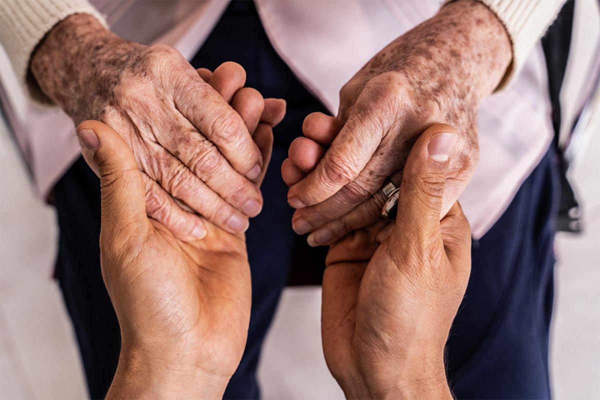 Pair of hands holding another pair of hands