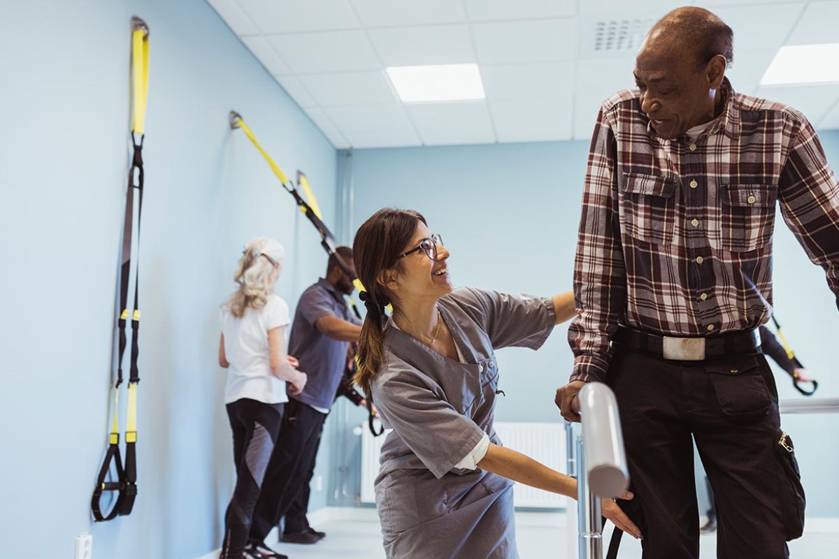 Patient and caregiver in physical therapy
