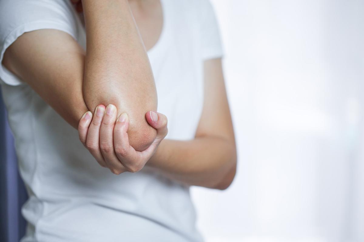 Hand clenching elbow
