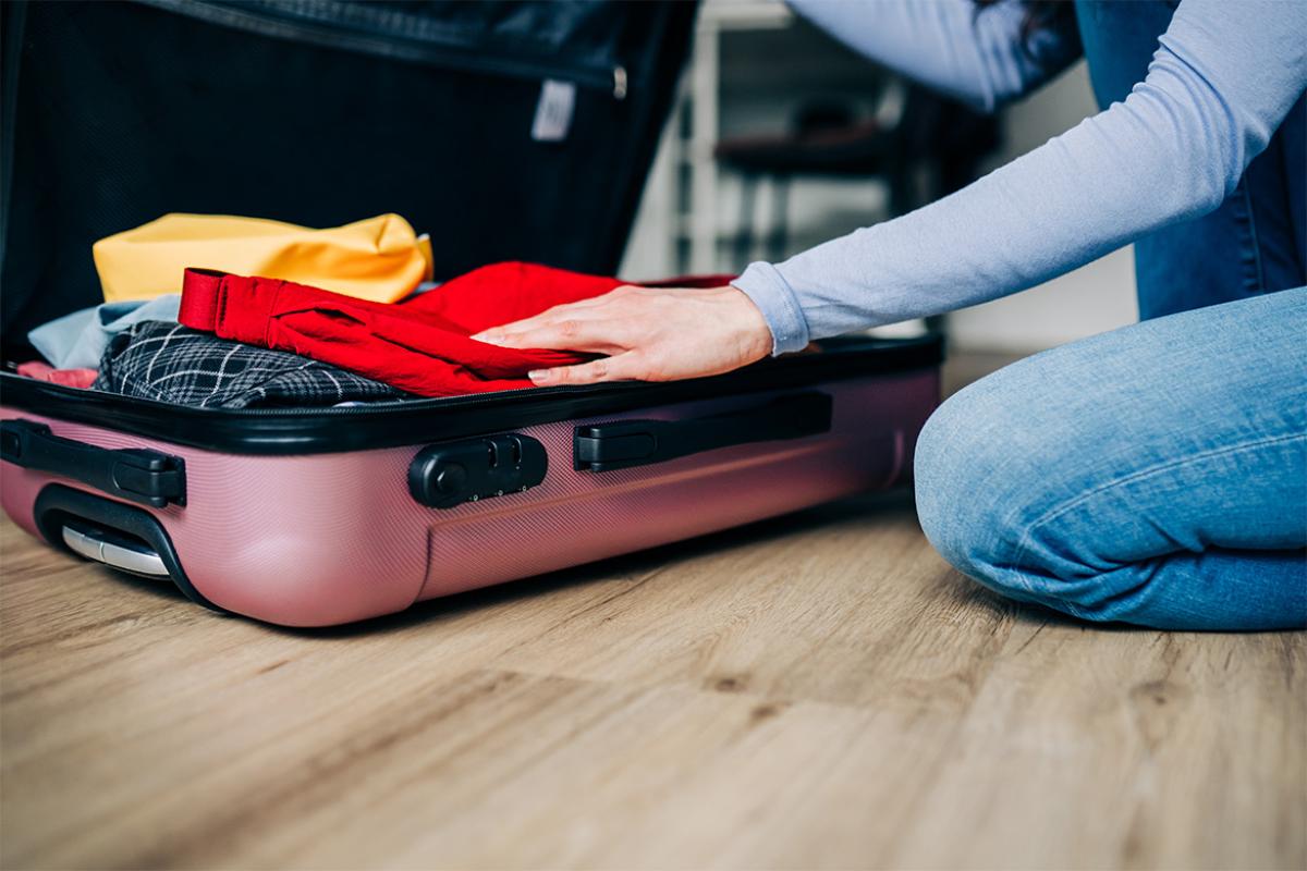 Person packing a suitcase