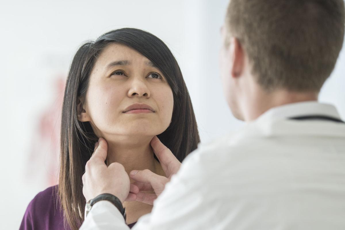 Patient receives a thyroid examination for a cancer check