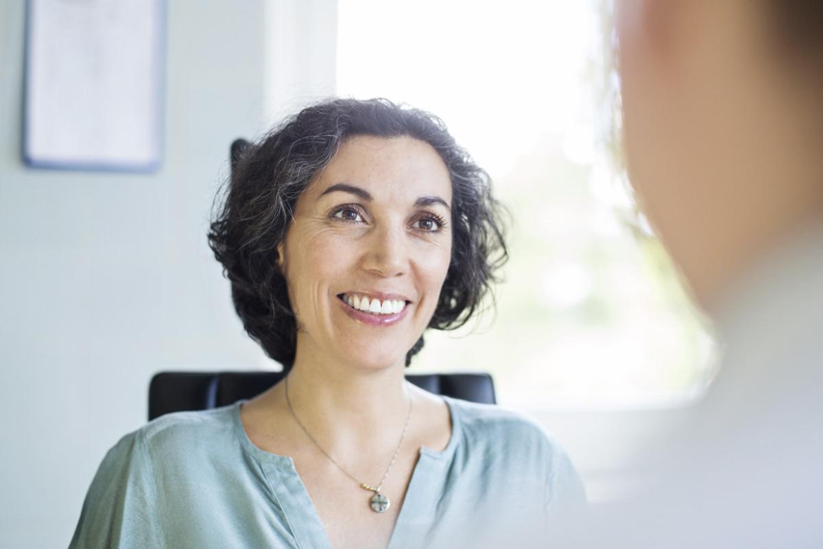 Person smiles at another individual