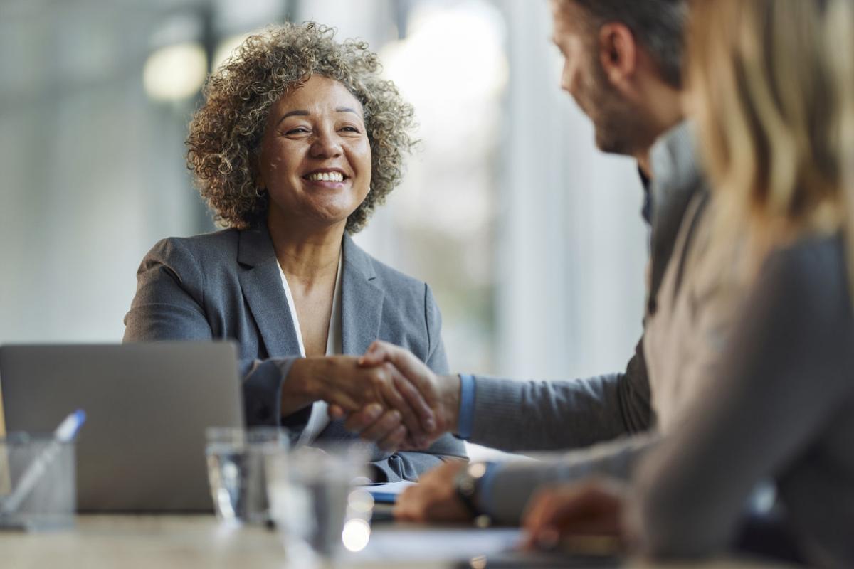 Smiling businessperson shaking hands