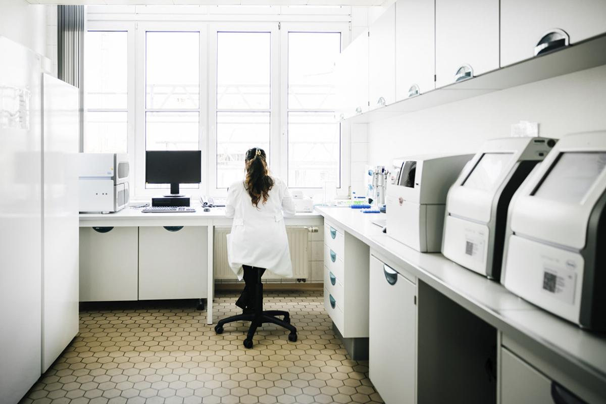 Person sits at a desk in a laboratory