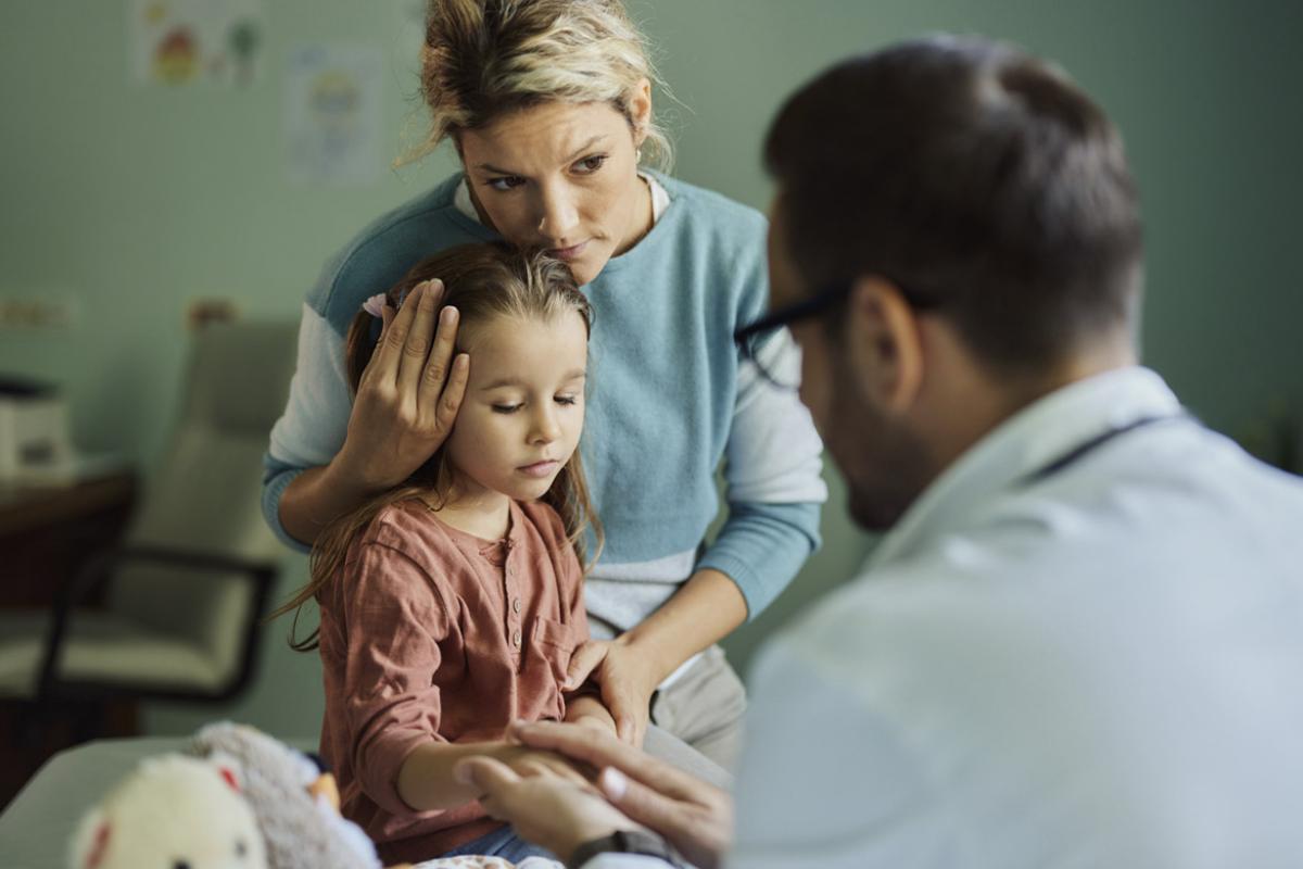 Mother comforts child during an appointment