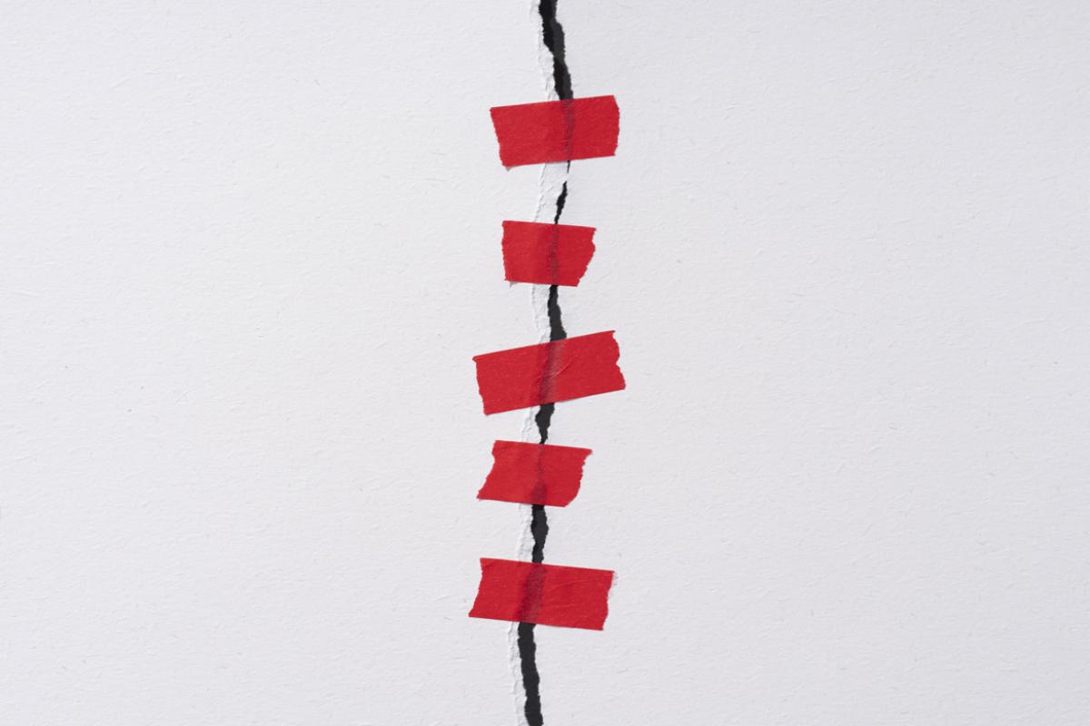 Red tap covers a crack in a wall