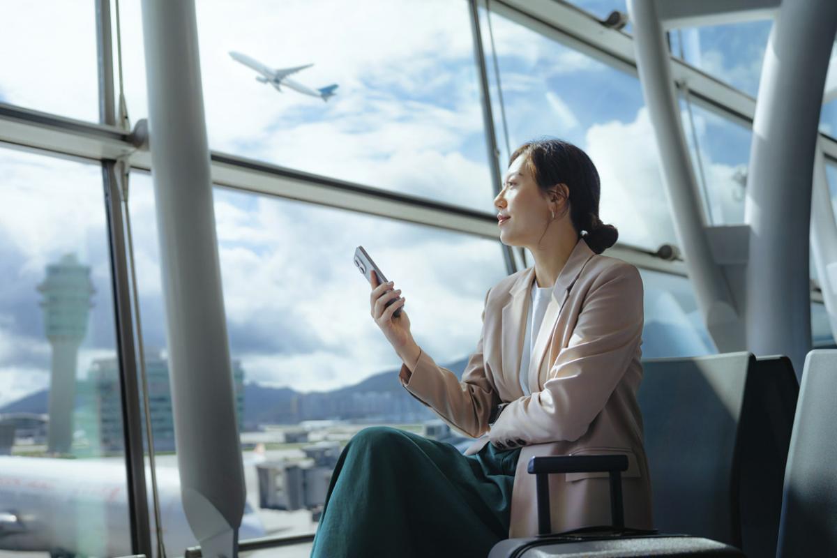 Smiling person sits at the airport