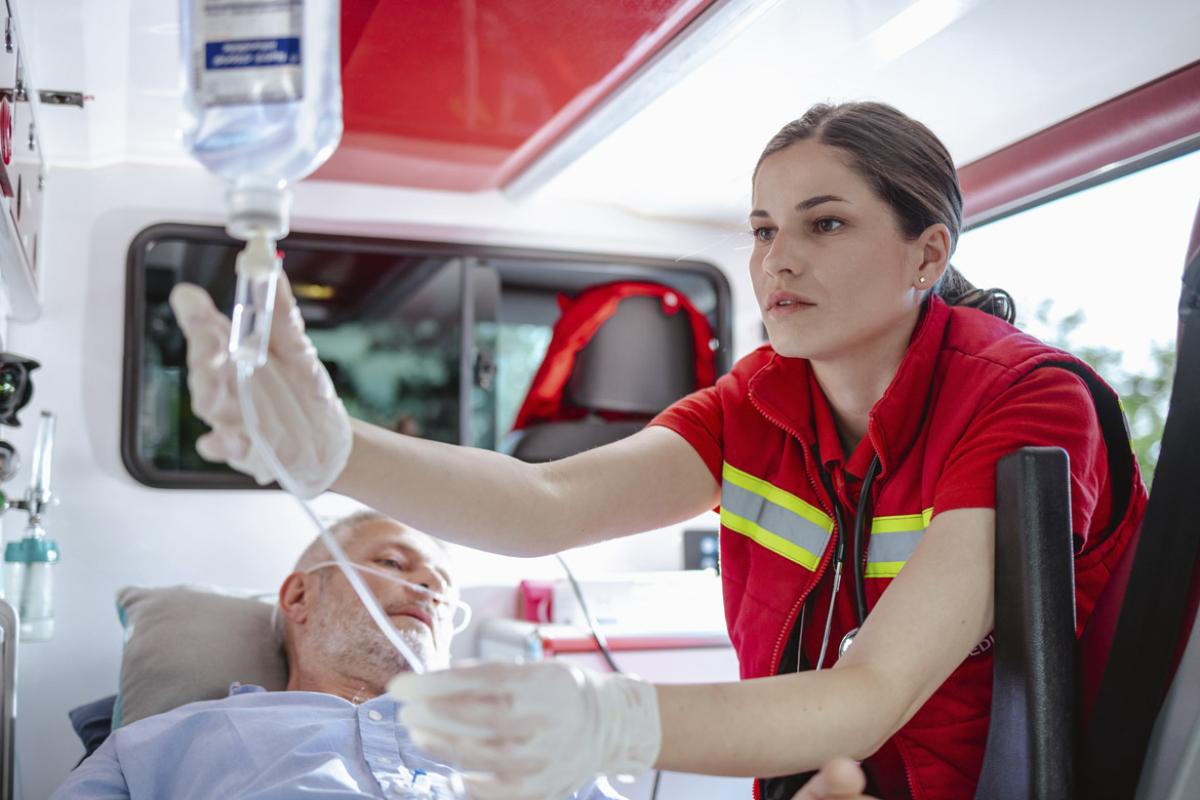 Paramedic providing medical assistance to patient in ambulance 