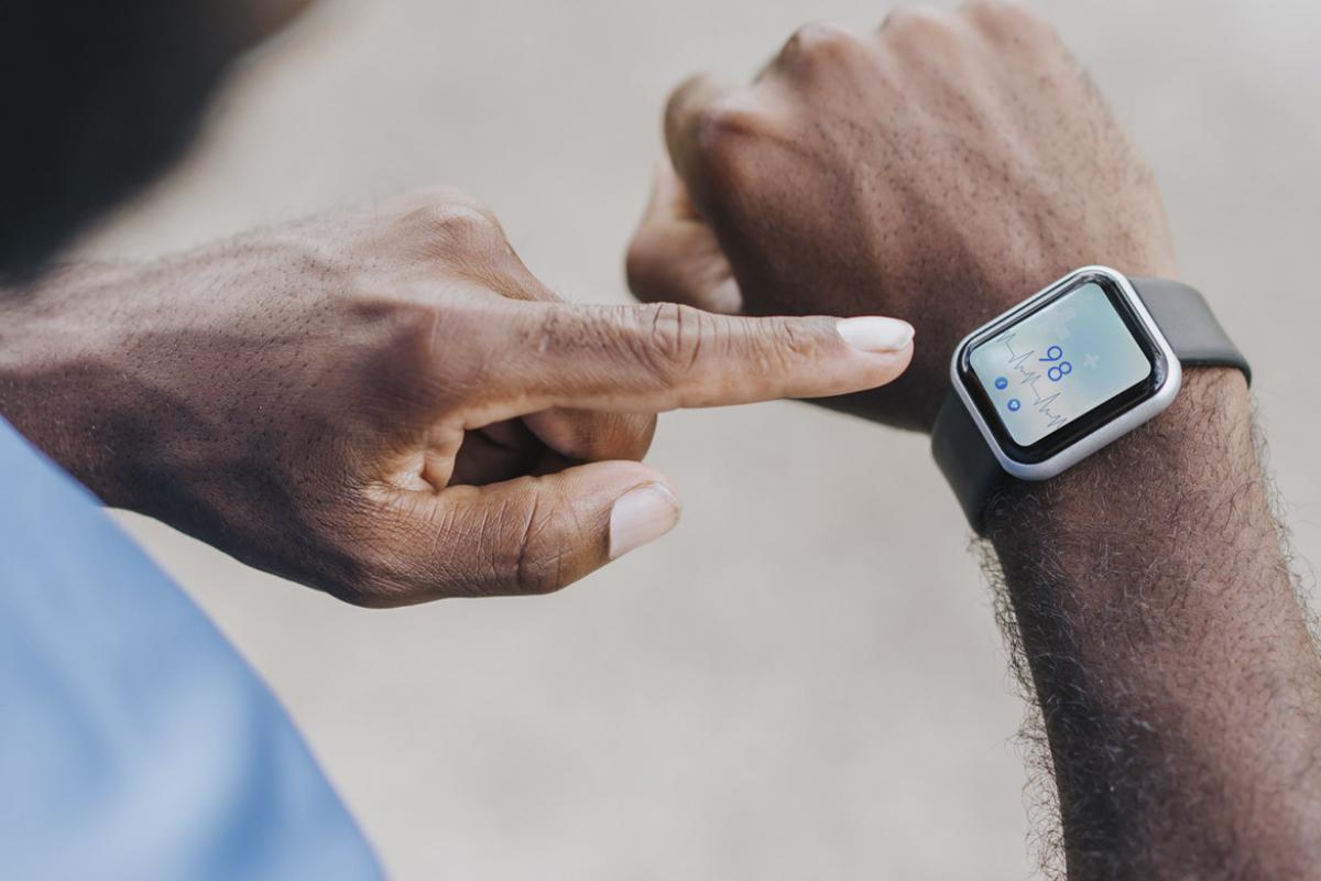 Finger points to heart rate on smartwatch