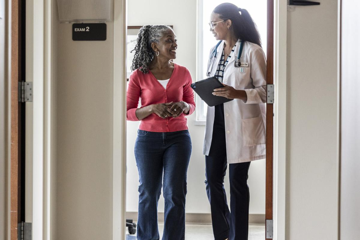 Physician and patient standing in doorway