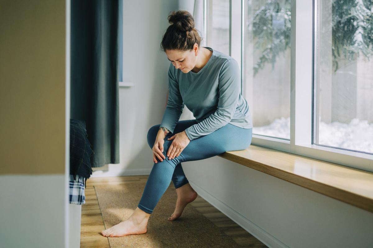 Woman with hands on knee