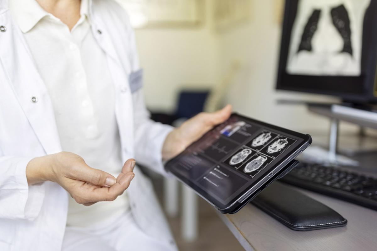 Physician looking at a scan on a tablet