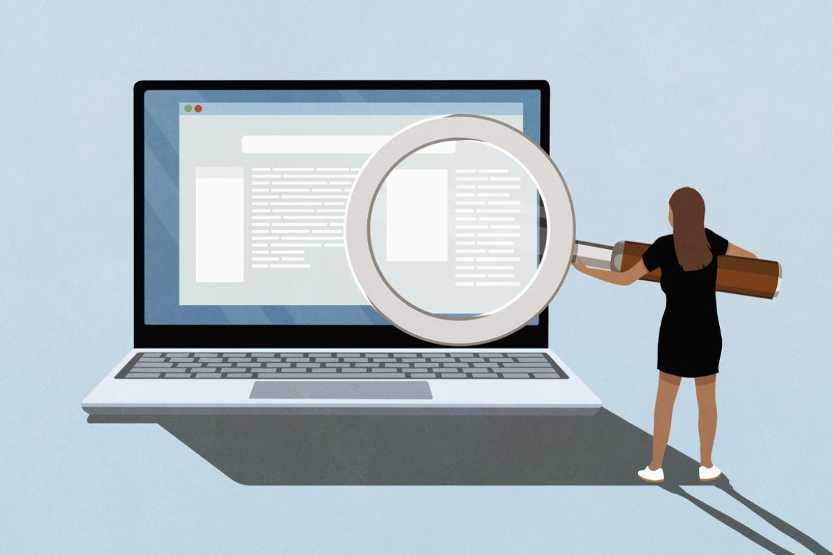 Figure holds a giant magnifying glass in front of a laptop