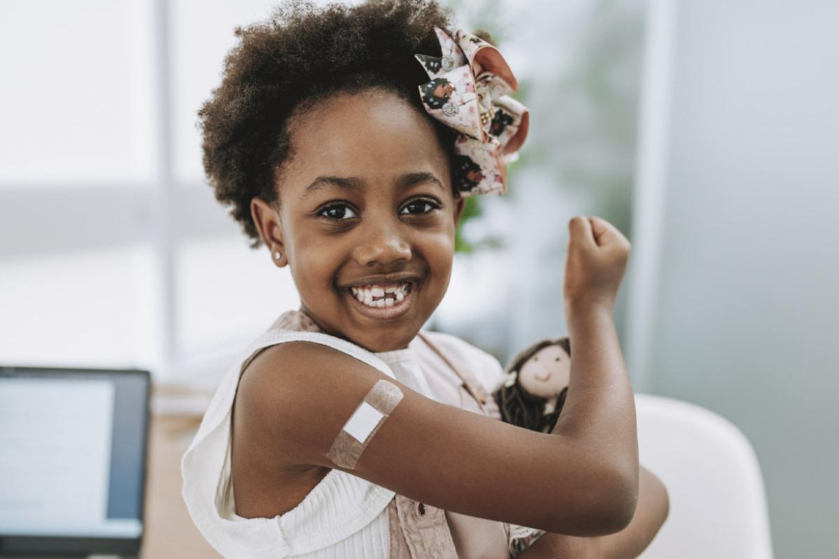 Smiling child with bandage on arm
