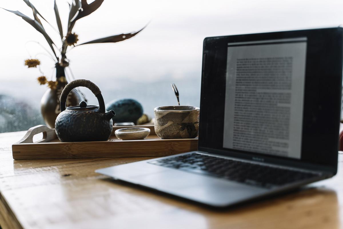 A laptop and a cup of tea sit together