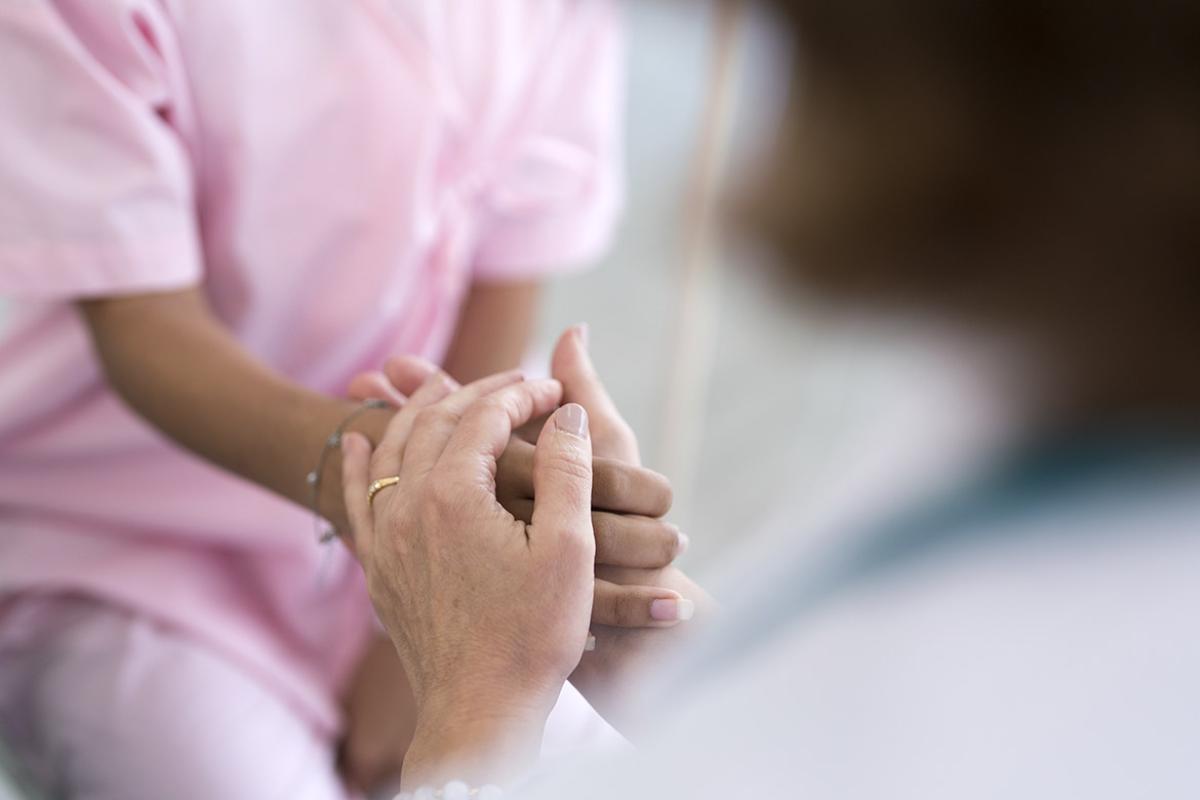 Doctor holding patient's hand