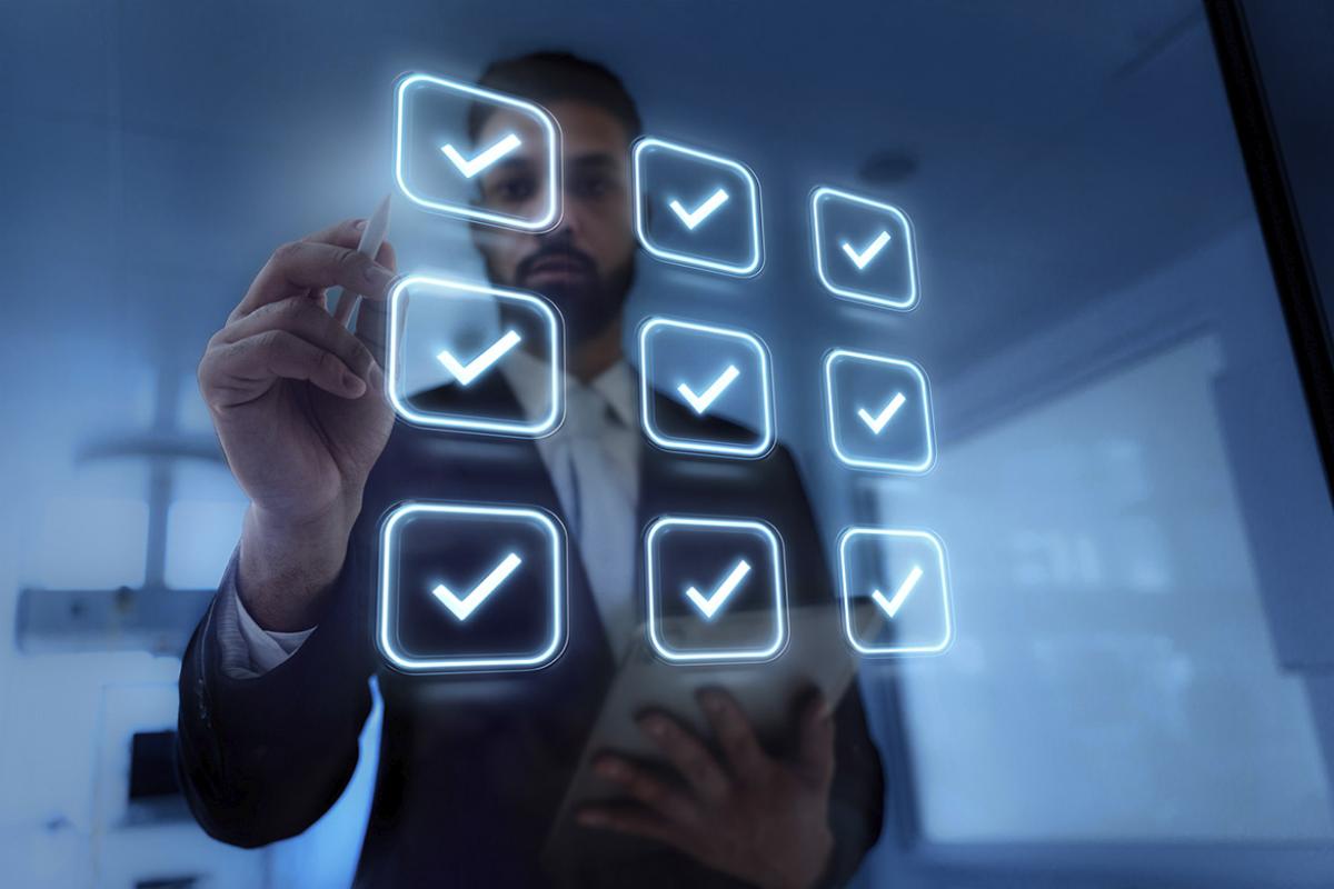 Businessperson stands in front of virtual check boxes