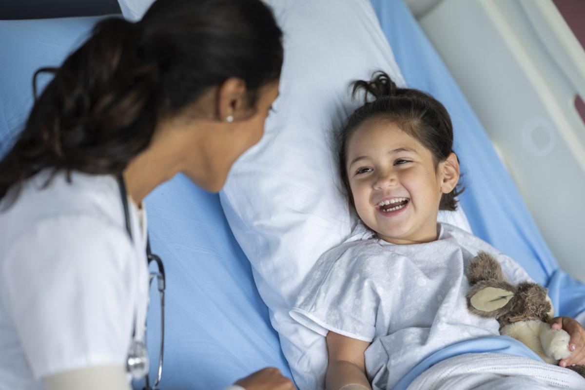 Smiling young child in hospital bed