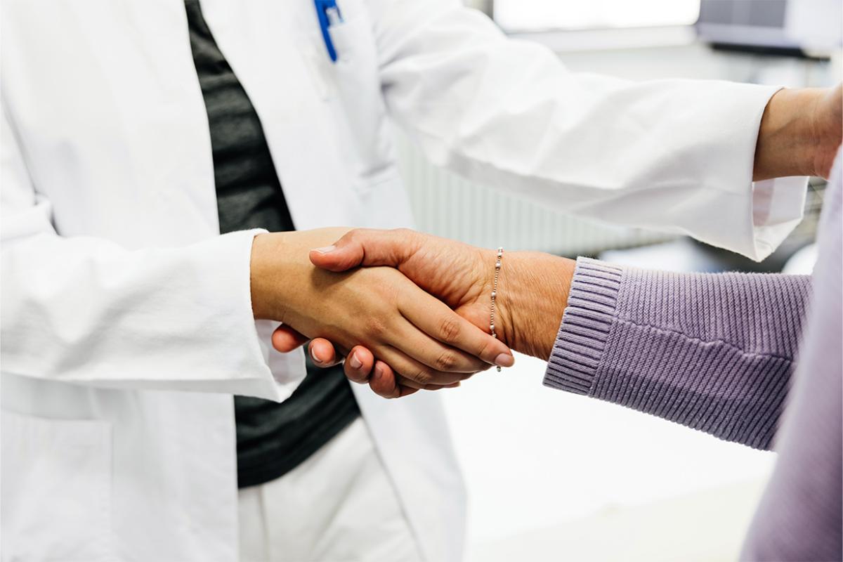 Two people shake hands