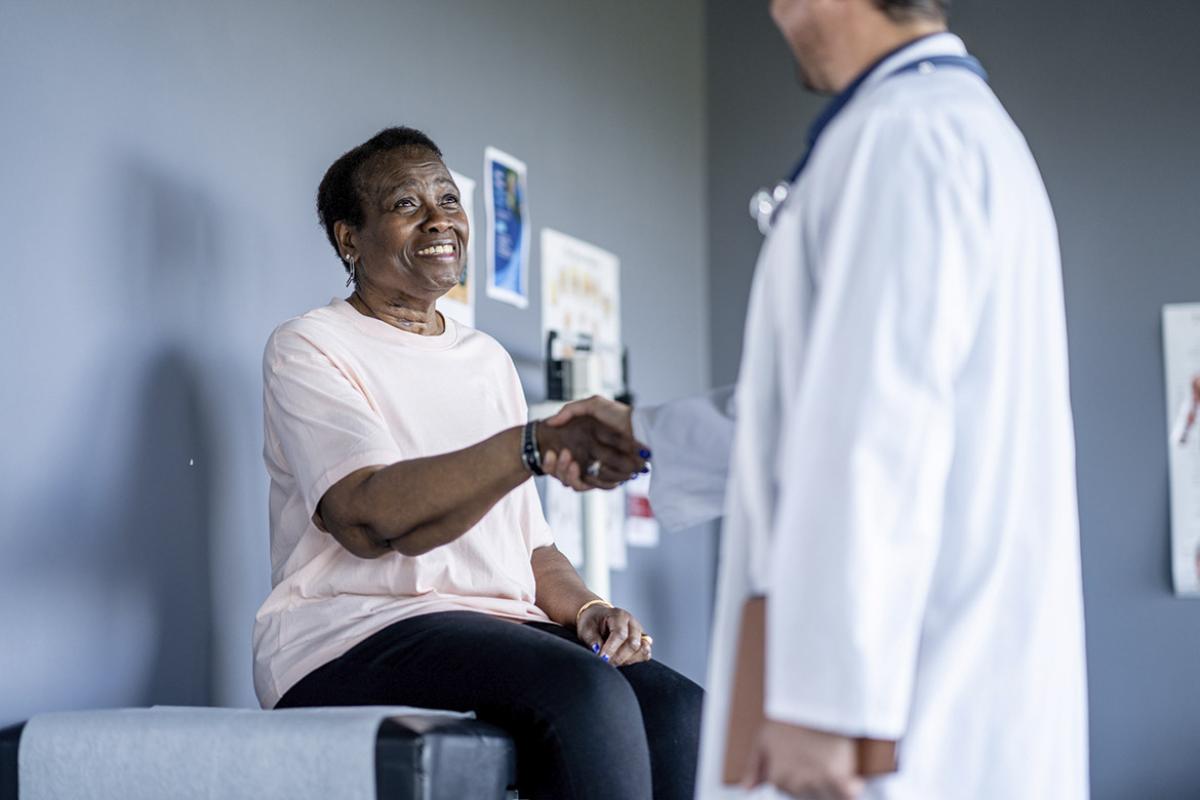 Smiling patient greets doctor
