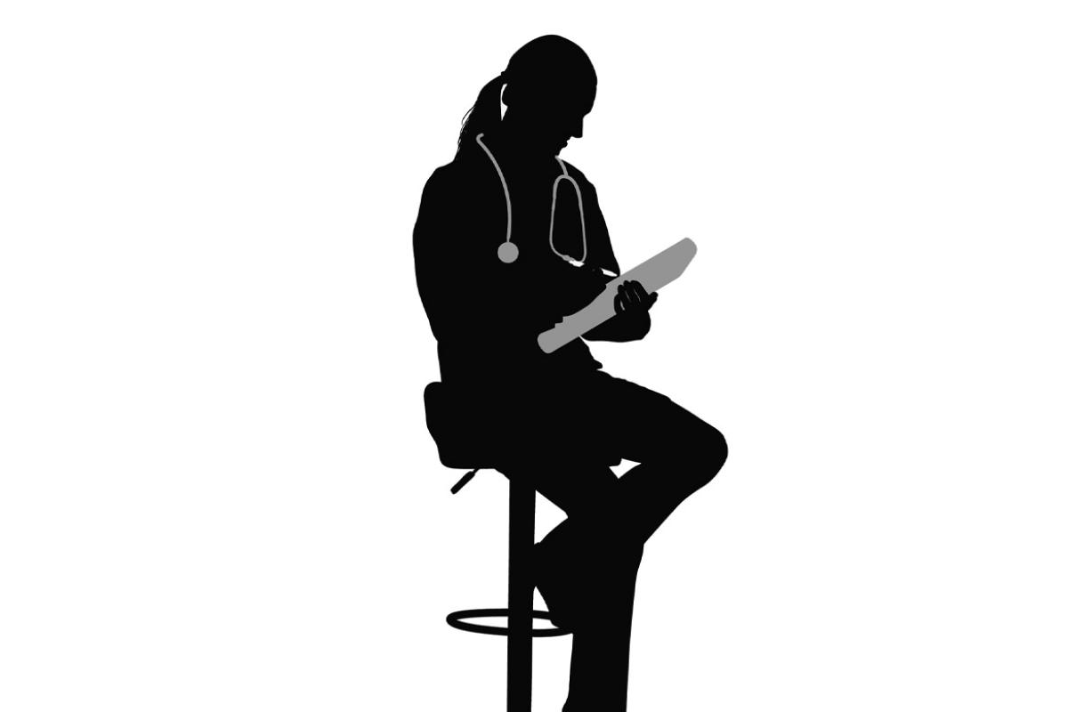 Silhouette of a doctor writing