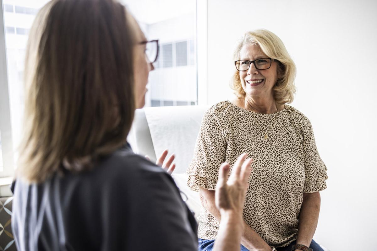 Smiling patient listens to health care worker