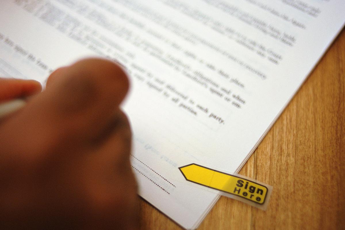 Hand signs a contract