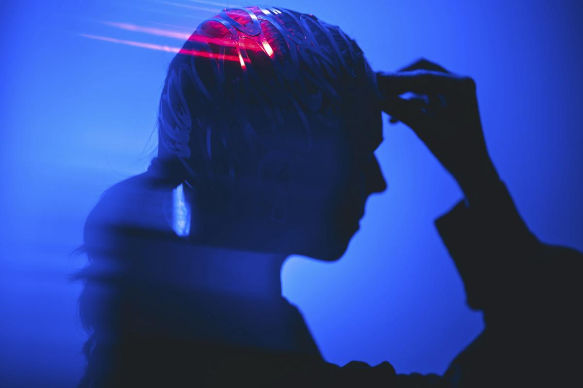 Profile of a person clenching forehead
