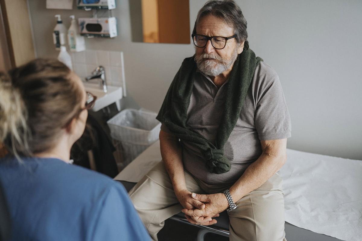  Patient in discussion with medical worker during visit at hospital