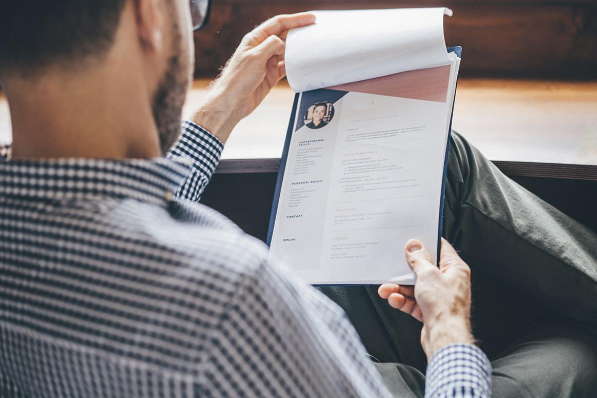 Businessperson reviews resume information