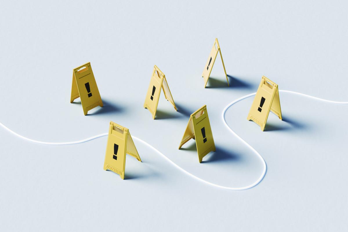 Winding path through foldable yellow floor signs with with exclamation marks 