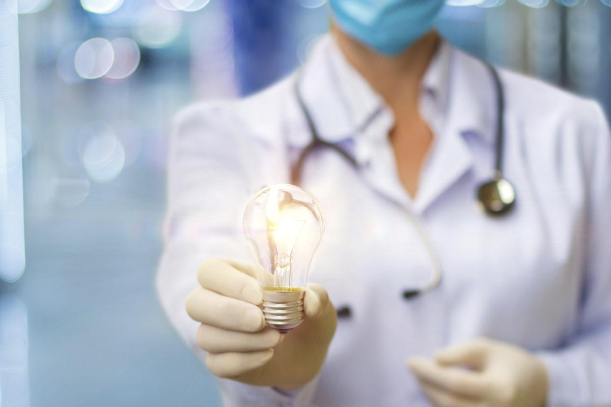 Physician holds a light bulb