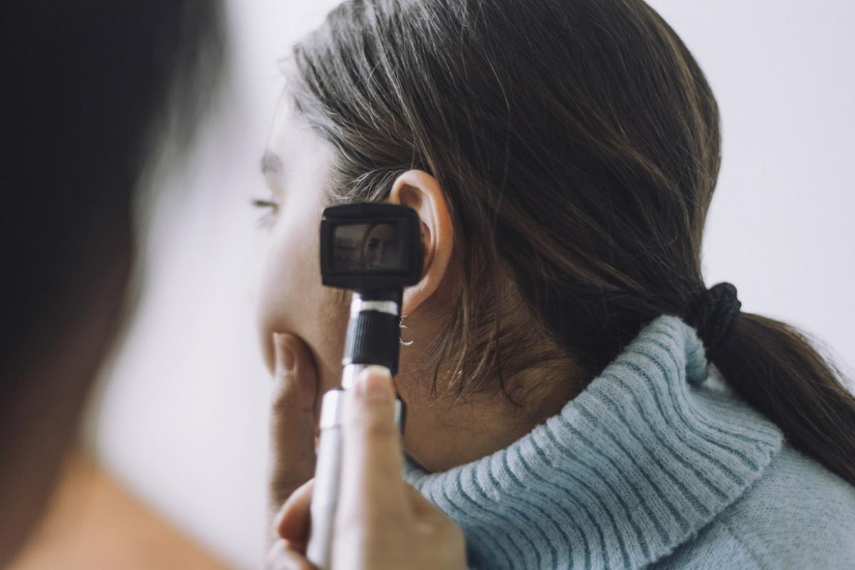 Doctor examining patient's ear