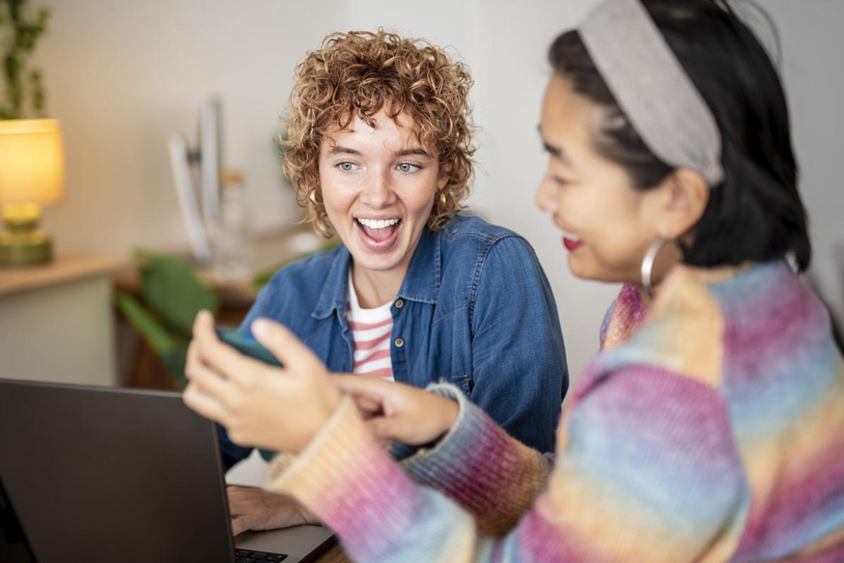 Two smiling colleagues working together