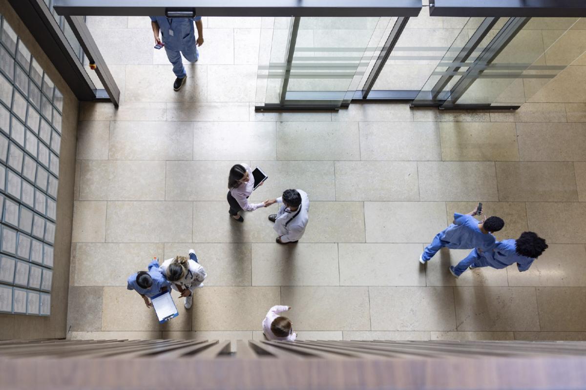 Group of people walking through an entrance hall at a hospital 