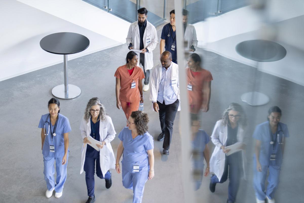 A group of health care workers walk in a hall