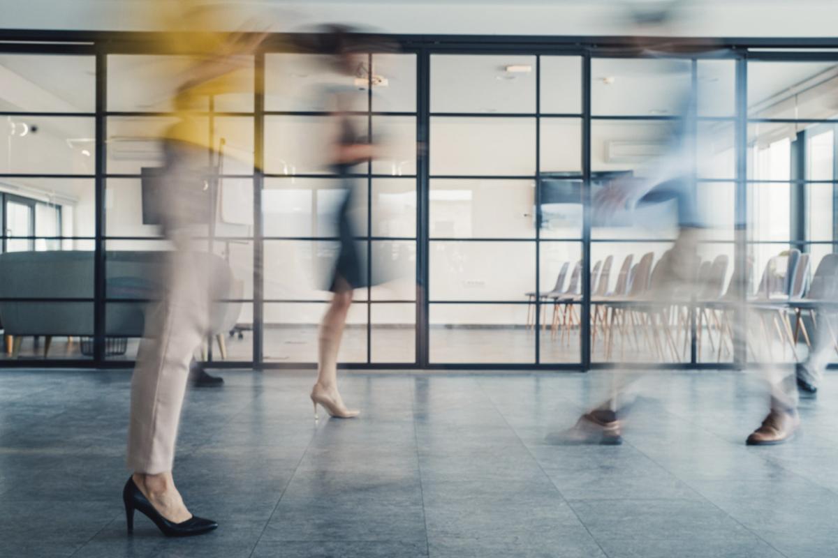 Blurry figures walking in a hallway