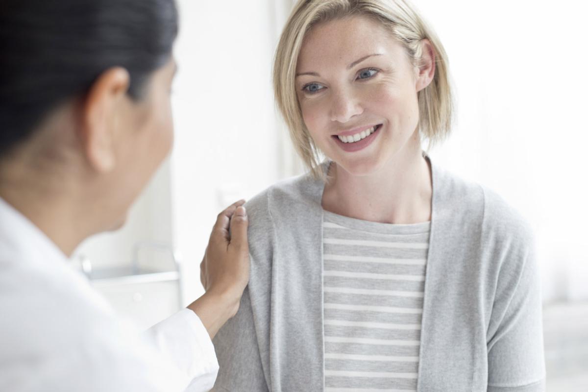 Doctor with hand on patient's shoulder