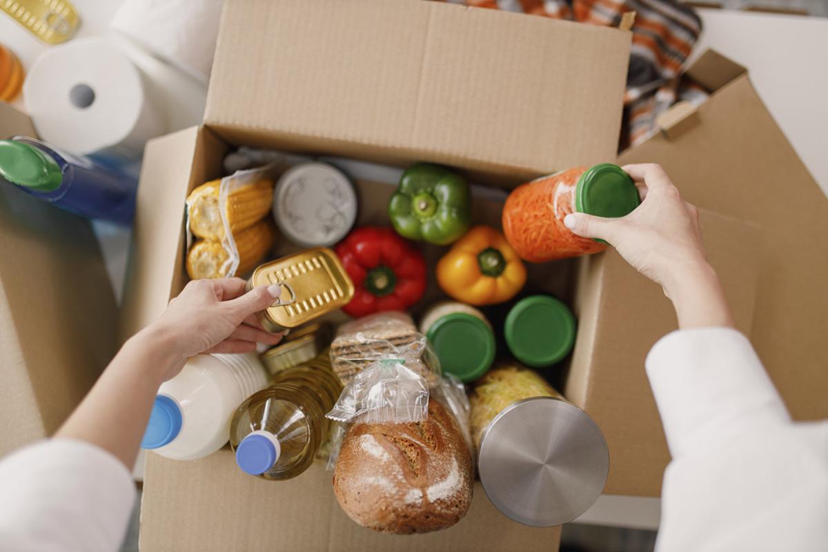 Person packing up food in a box