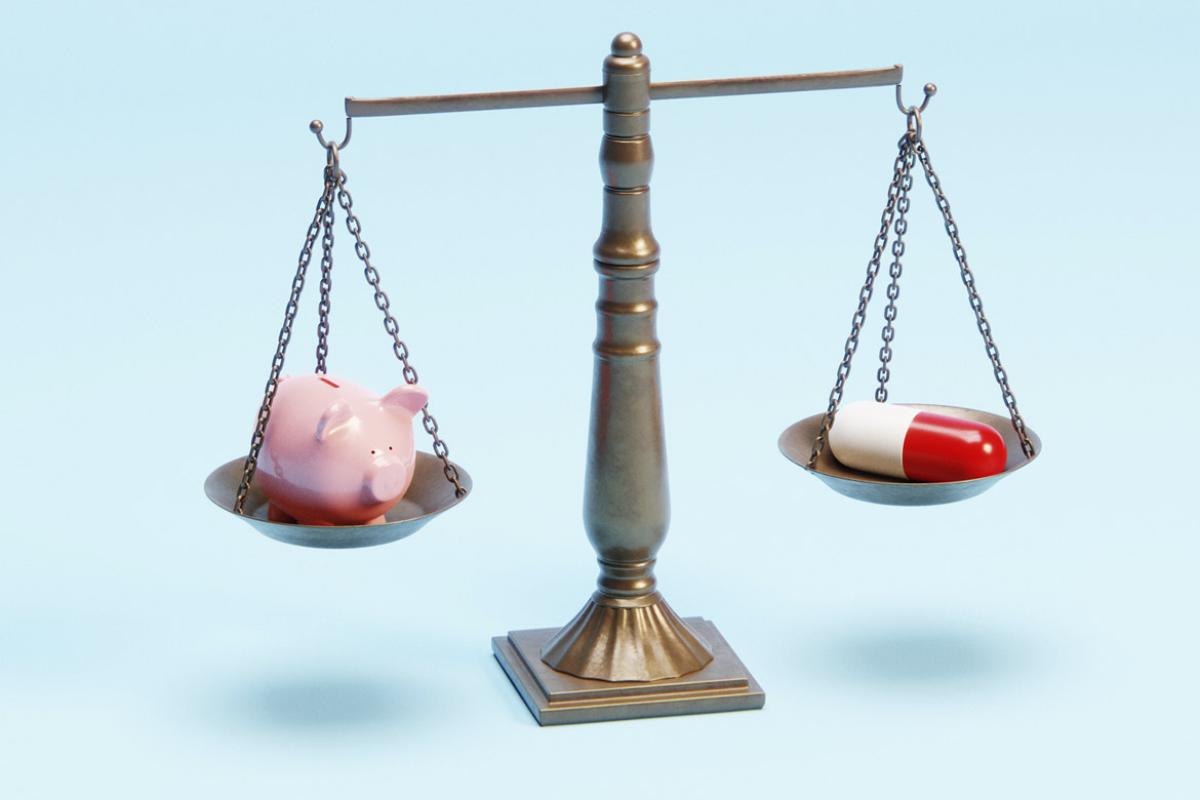 Justice scale with a piggy bank and an oversized pharmaceutical pill 