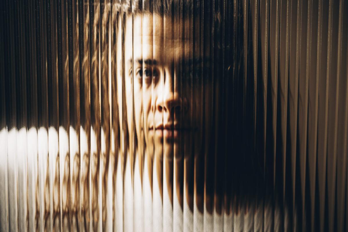 Woman behind textured glass