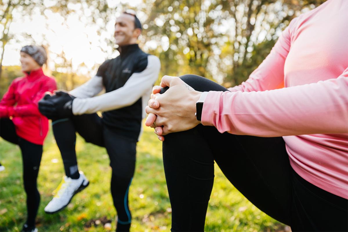 Group of people stretch during a workout