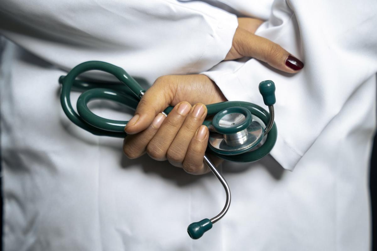 Hand holds stethoscope