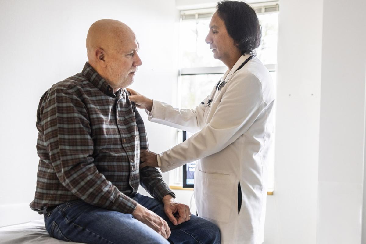 Doctor giving patient a joint exam in doctor's office