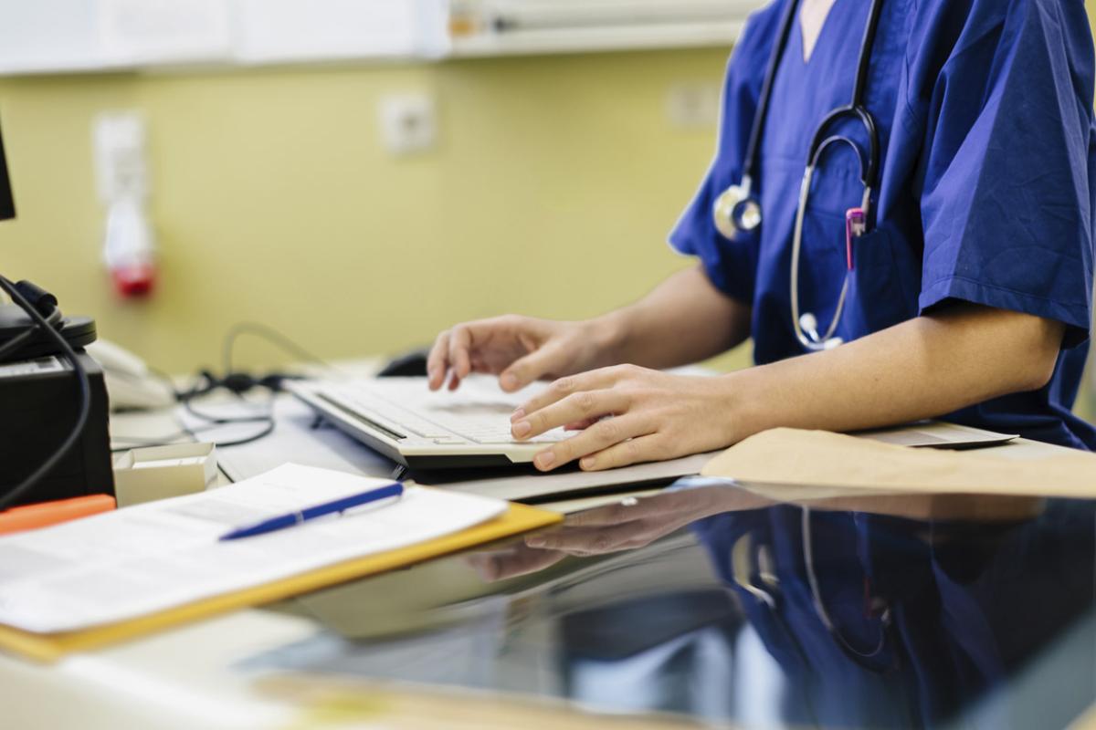 Doctor works at a hospital computer