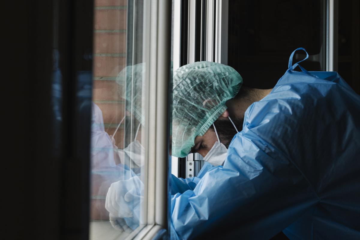 Slumped physician at a window
