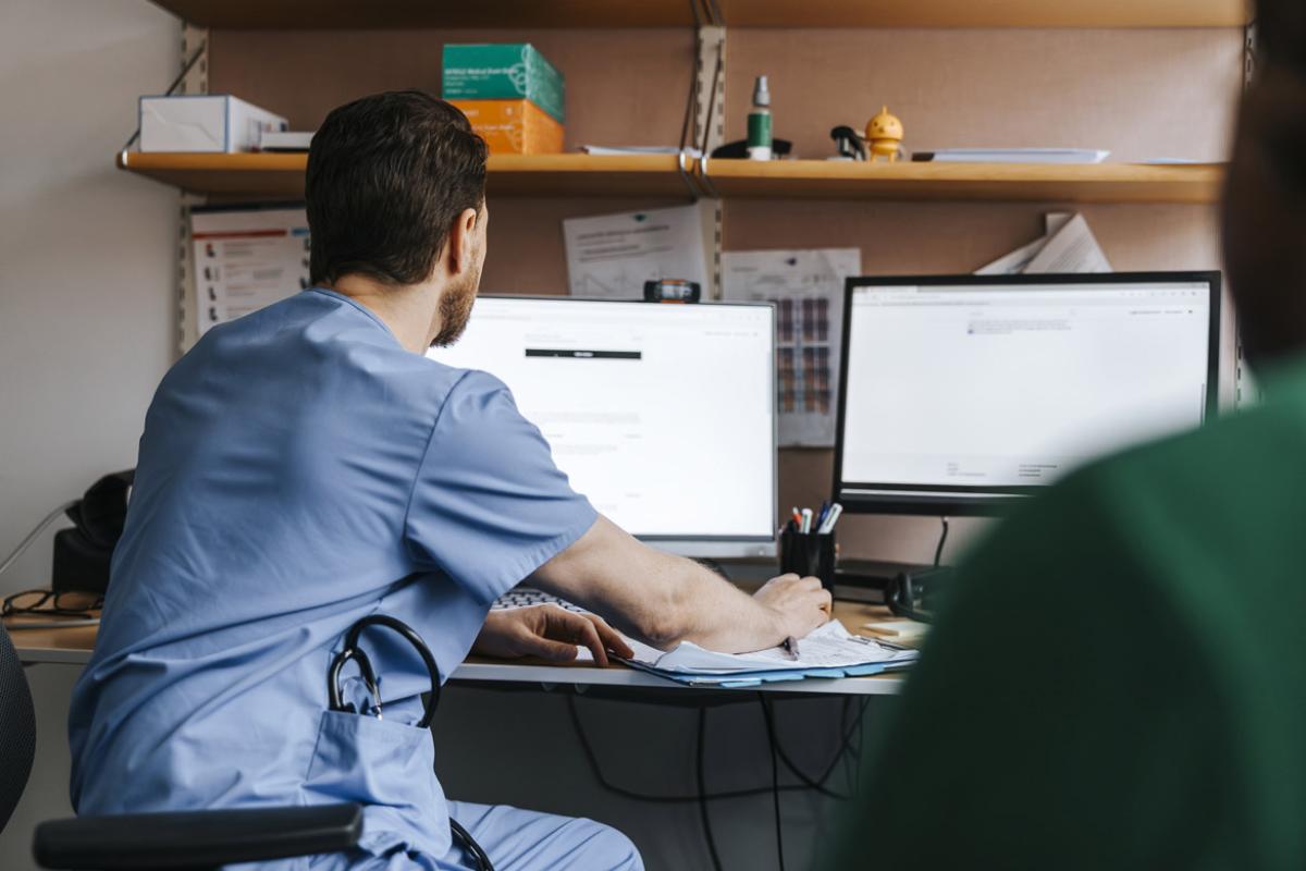 Physician checks medical records on computer