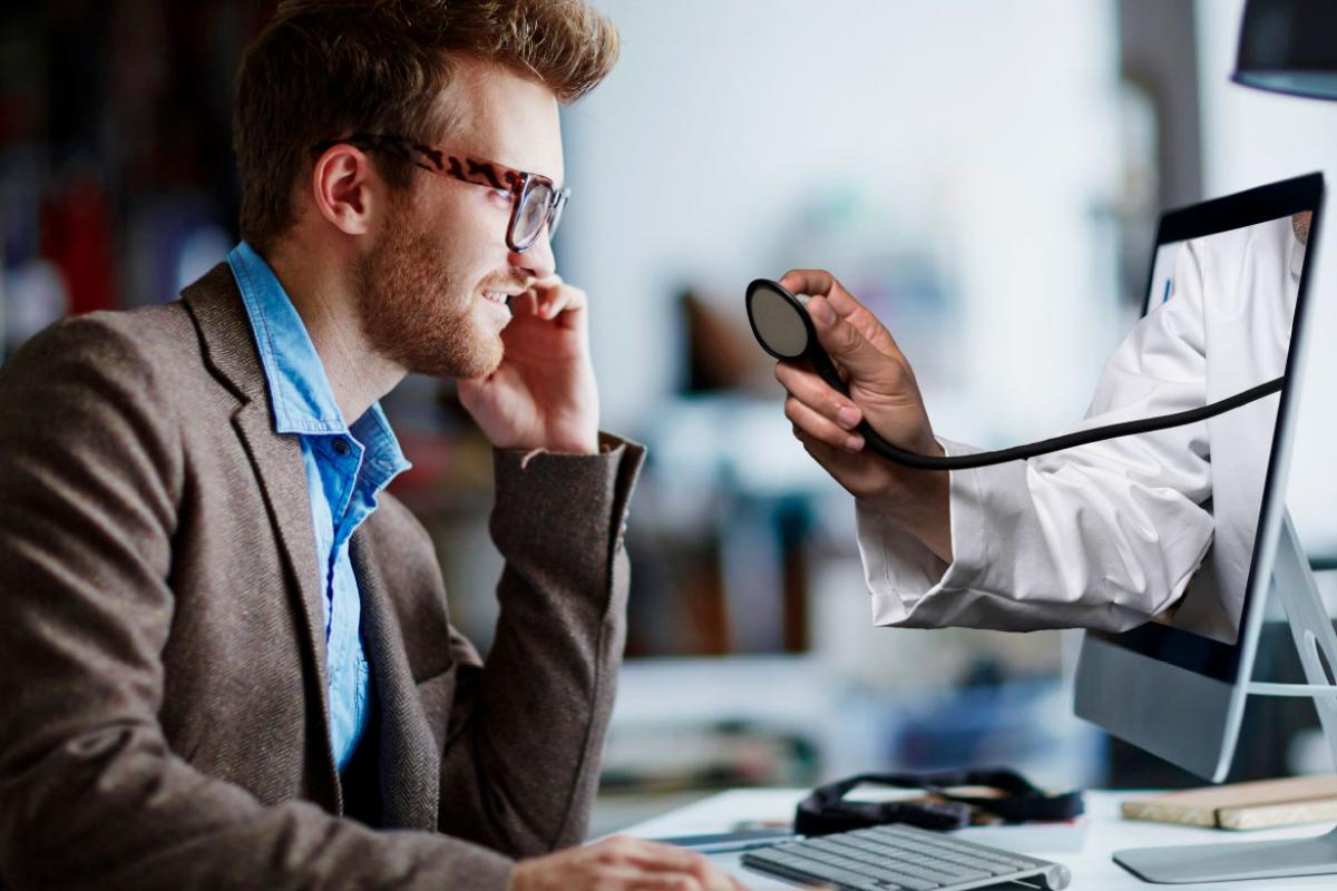 Physician hand coming from computer screen for patient