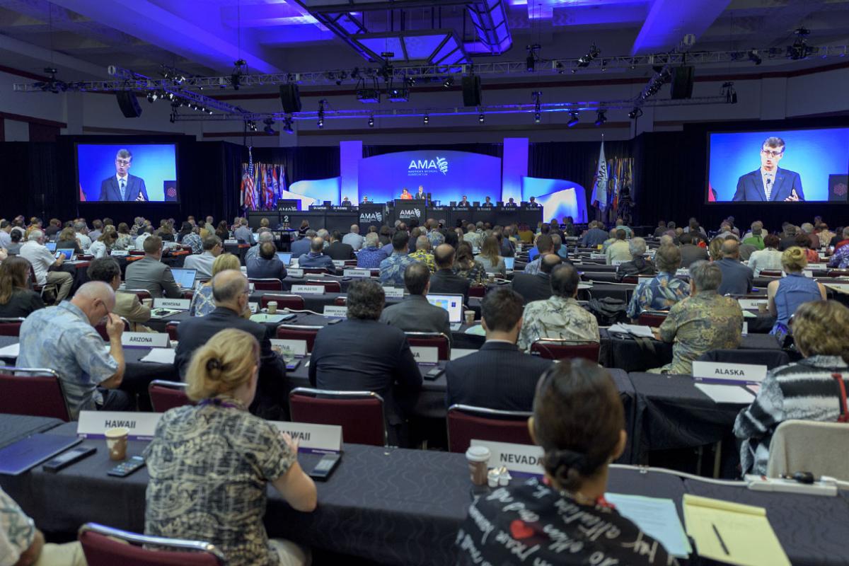 Crowd at large AMA meeting listening to a speaker