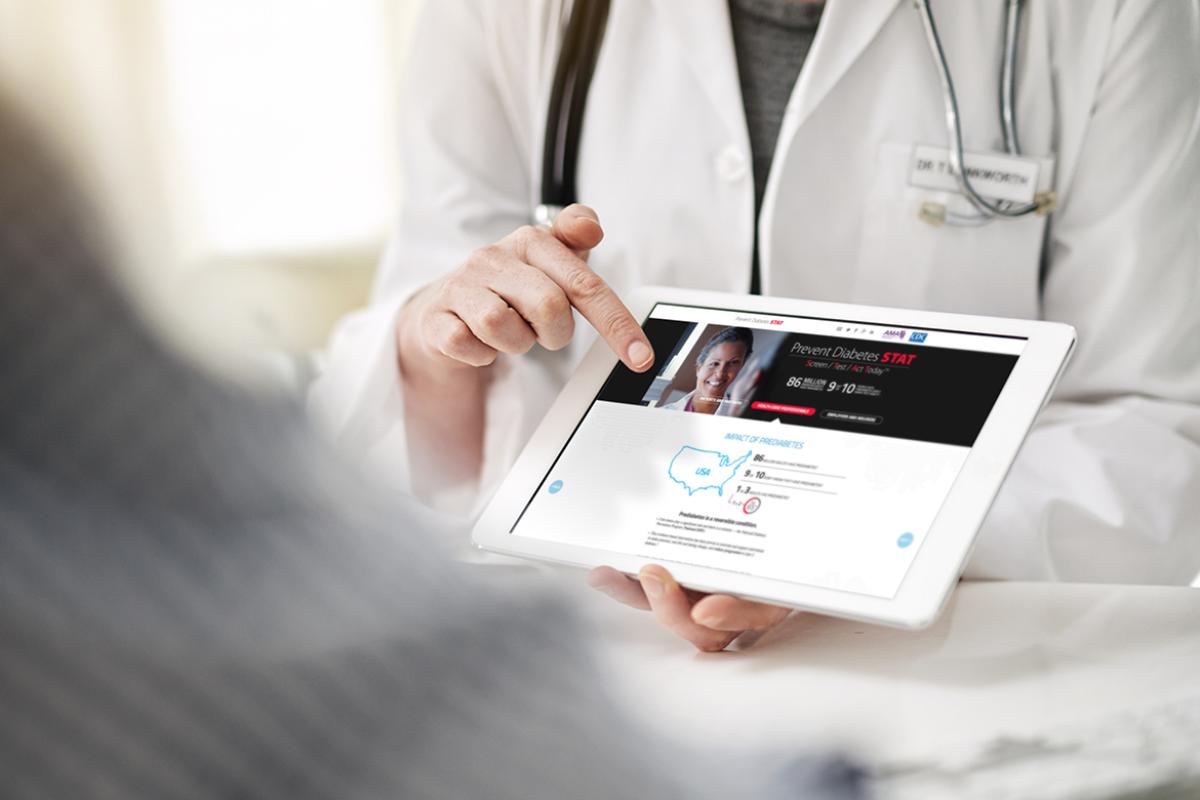 Physician displaying prediabetes app on tablet for patient.